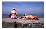 Couple-sunbathing,-Wales.